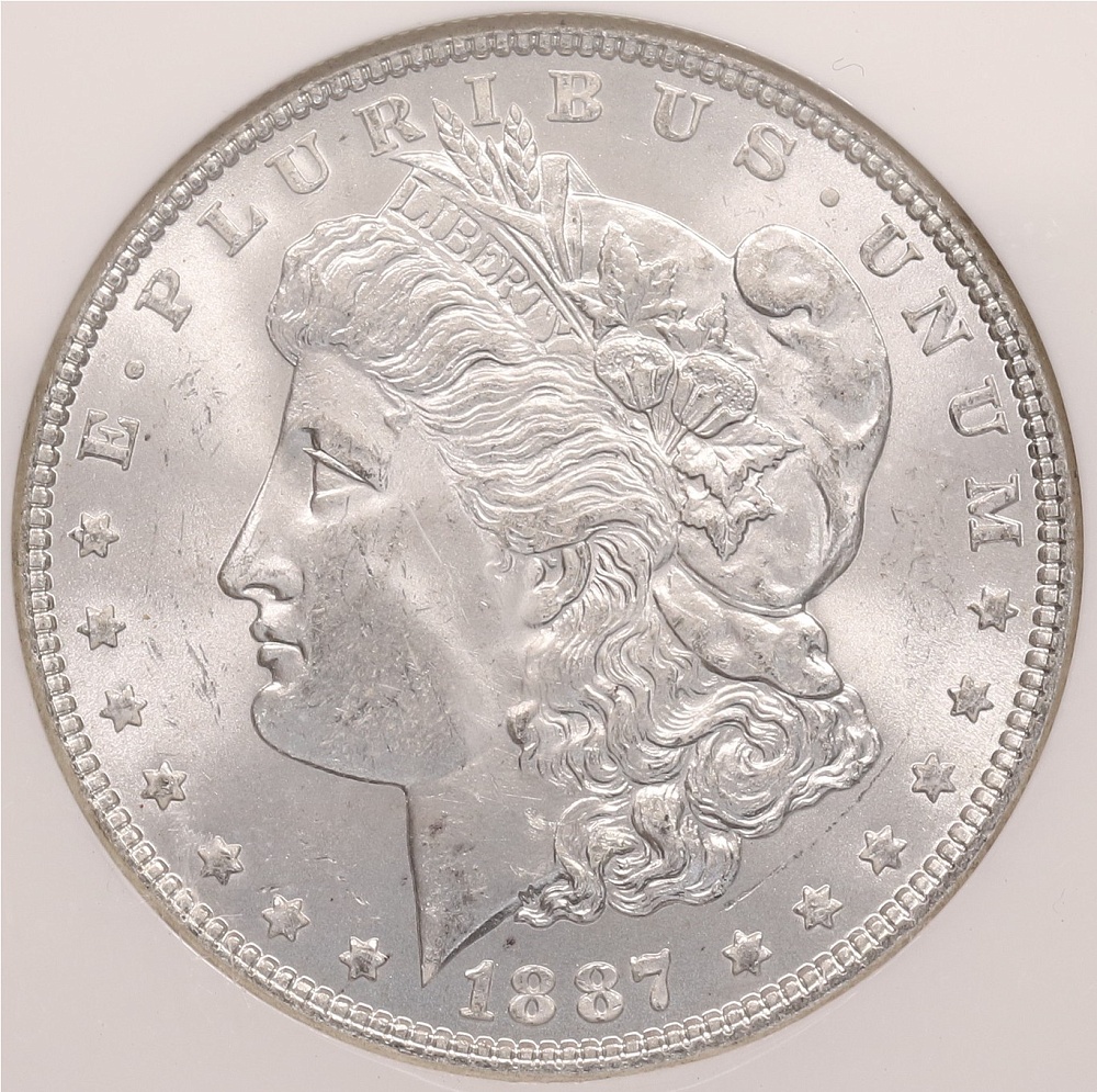 1 доллар 1887 года США «Доллар Моргана» в слабе NGC (MS64) — Фото №1
