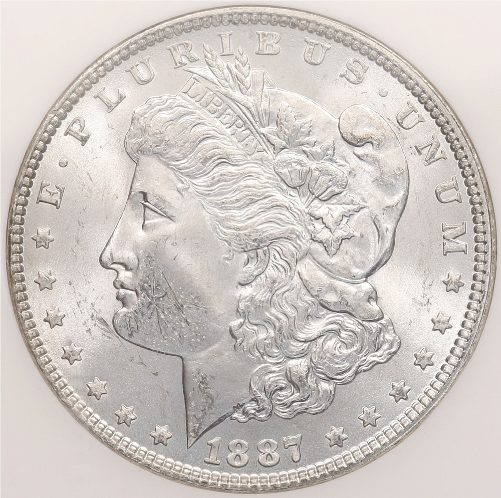 1 доллар 1887 года США «Доллар Моргана» в слабе NGC (MS64) — Фото №1